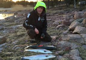 Filip with todays catch of fish on the cliffs